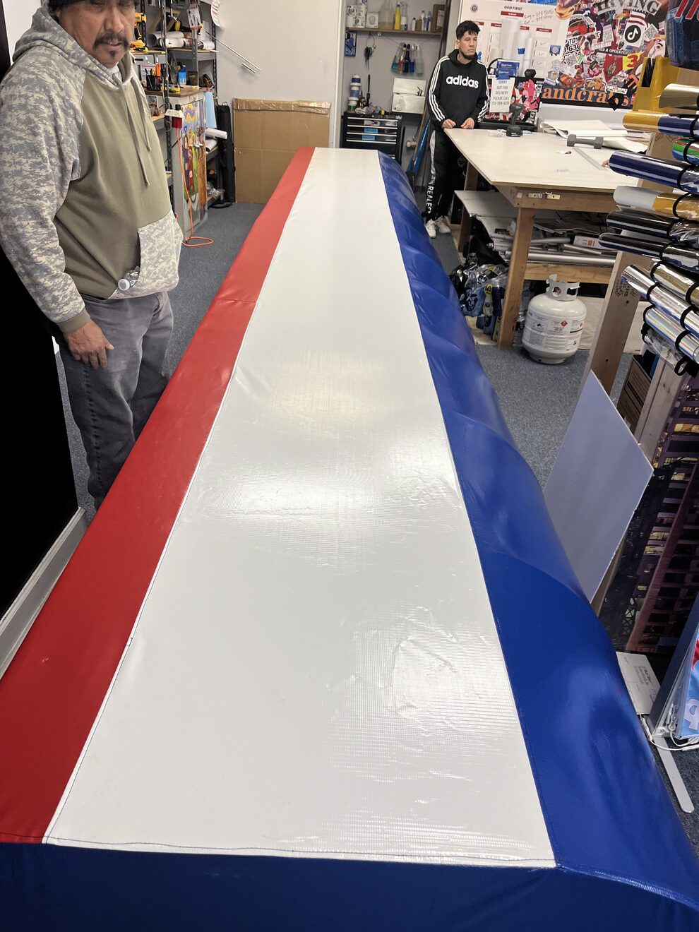 Finished red, white and blue awning panel on the shop floor before it goes out