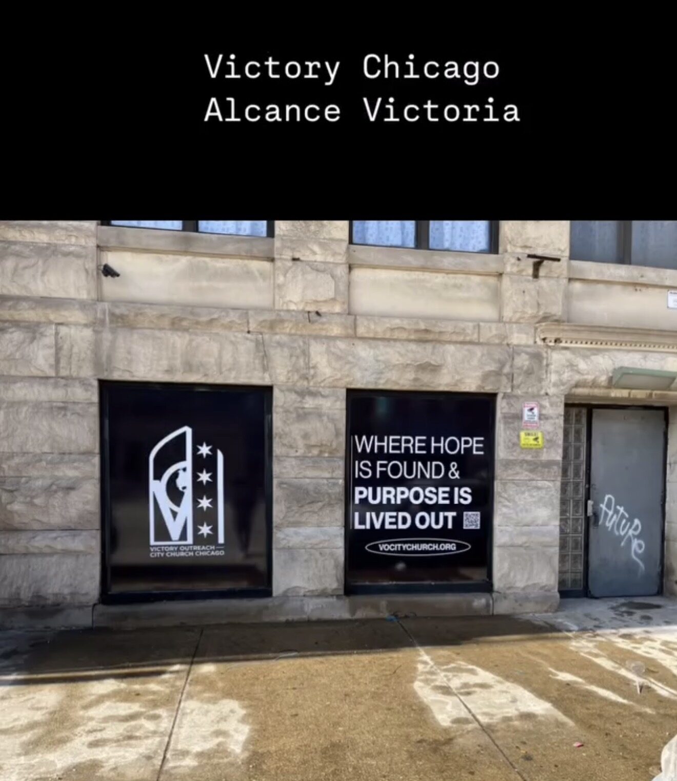 Storefront windows with black vinyl panels, white logo and mission lettering