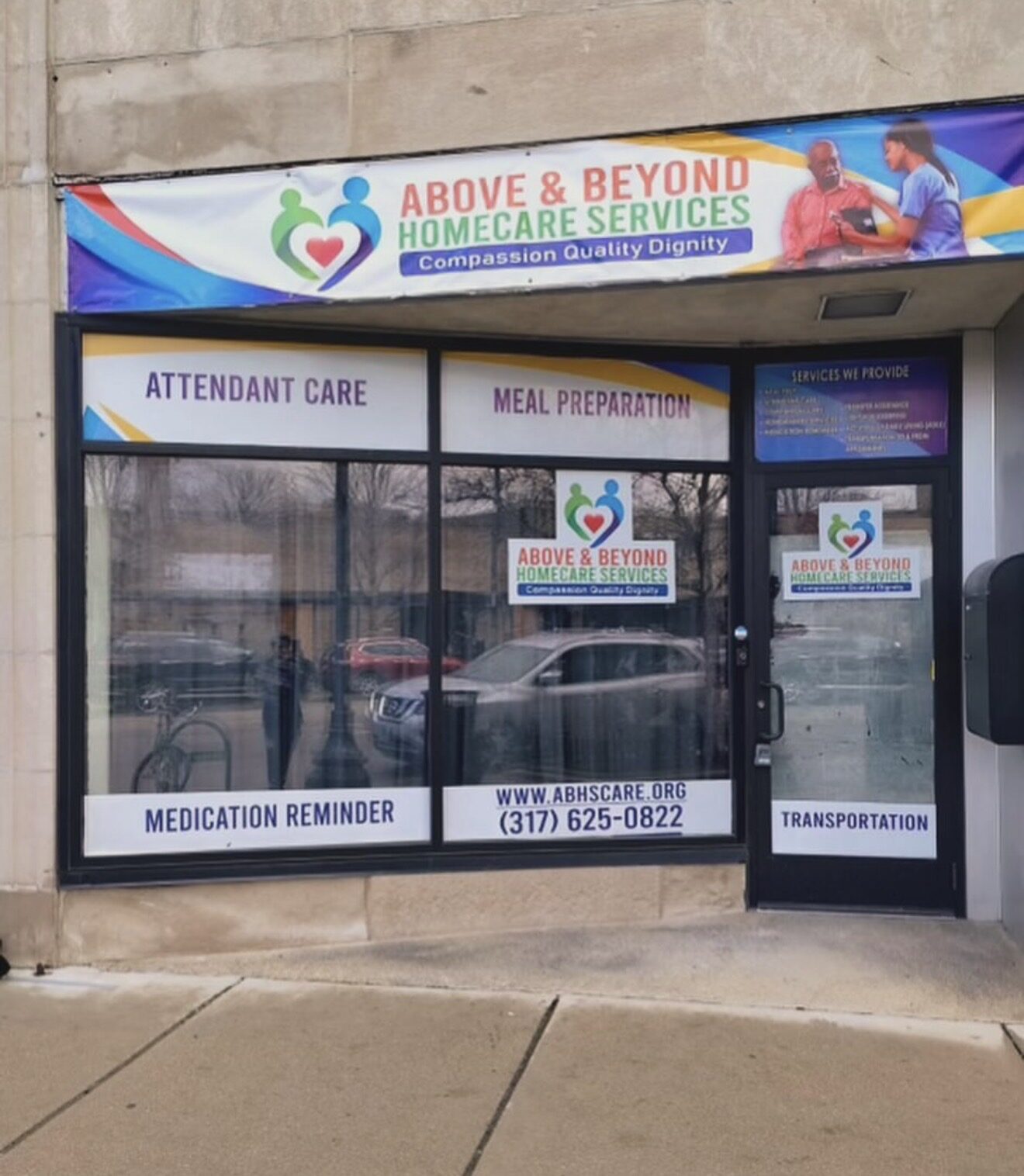 Above and Beyond Homecare storefront with printed banner and window graphics