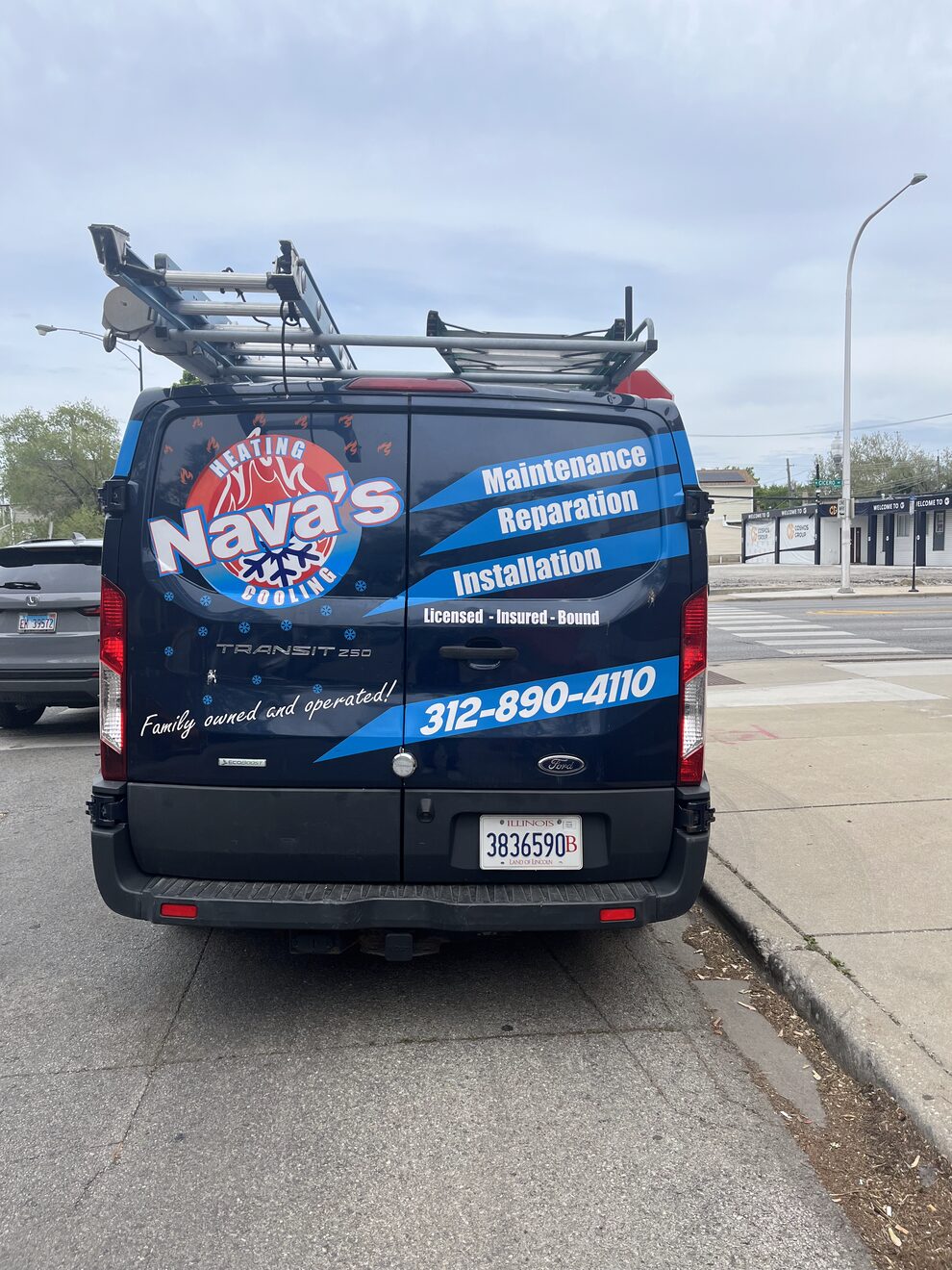 Nava's Repair van wrapped in blue graphics listing maintenance, repair and installation