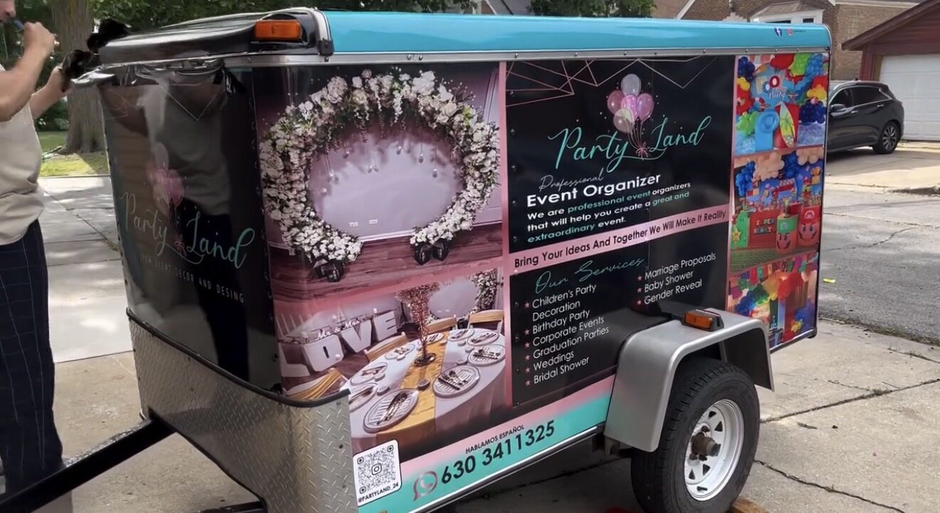Utility trailer fully wrapped in Party Land event decor graphics