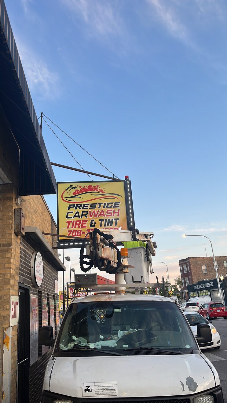Prestige Car Wash pole sign standing over the street