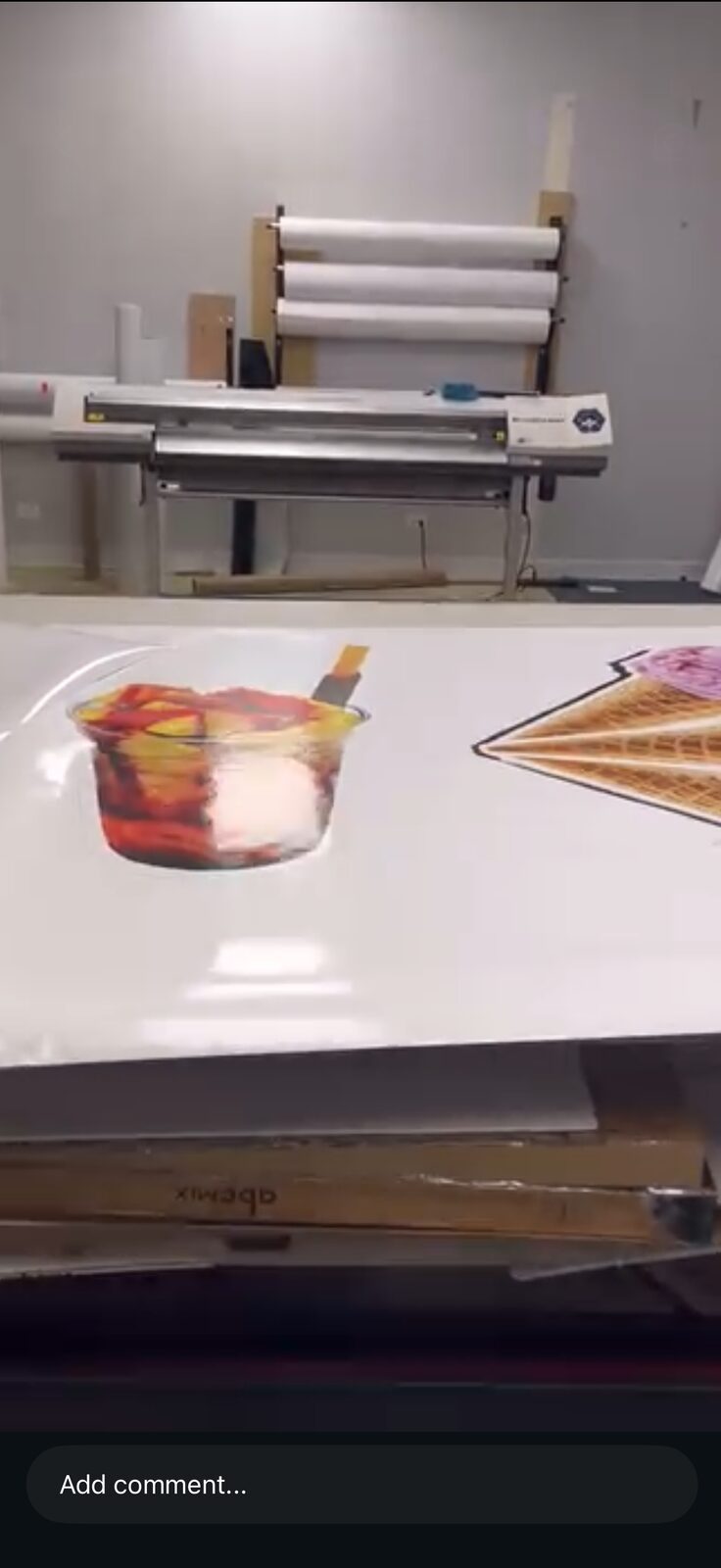 Laminator running printed graphics inside the shop